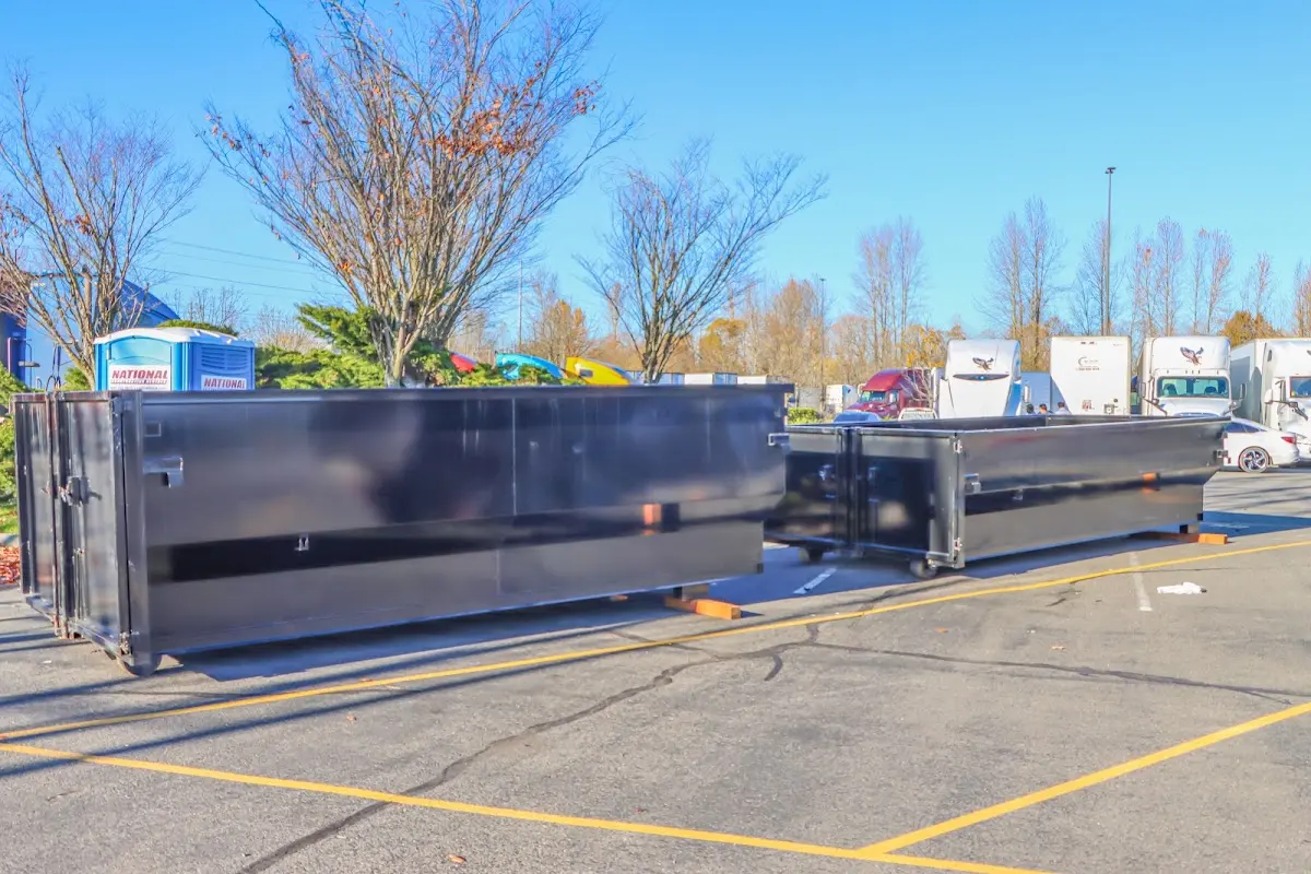 Professional dumpster rental service with roll-off container on residential driveway in Lemay
